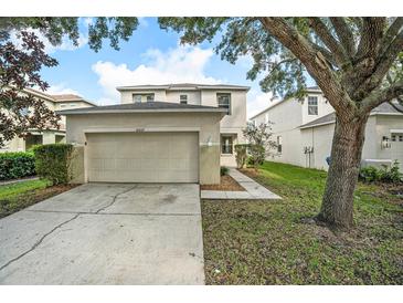 Two-story home with attached garage and landscaping at 18837 Litzau Ln, Land O Lakes, FL 34638