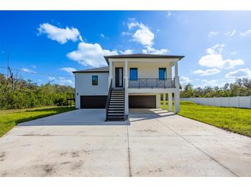 Modern two-story home with attached garage and metal staircase at 2316 S 46Th St, Tampa, FL 33619