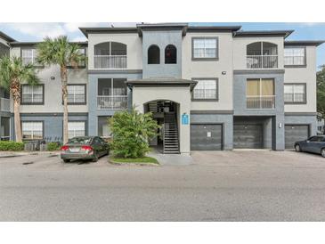 Exterior of a two-story building with gray and blue accents at 13113 Sanctuary Cove Dr # 104, Temple Terrace, FL 33637