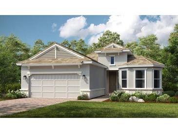 One-story home with a two-car garage and attractive landscaping at 11513 Casella Pl, Palmetto, FL 34221