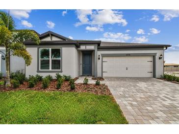 Charming single-story home featuring a well-manicured lawn and paved driveway at 13715 Brookside Haven St, Riverview, FL 33578