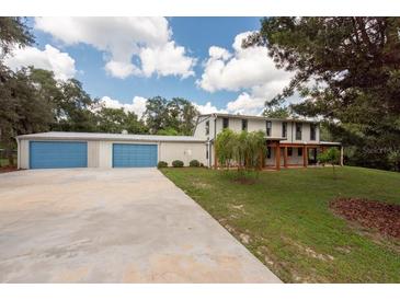 Two-story home with detached garage and covered patio at 12805 Flint Creek Rd, Thonotosassa, FL 33592