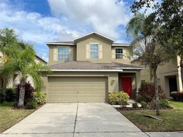 Two-story house with a two-car garage and red door at 2126 Richwood Pike Dr, Ruskin, FL 33570