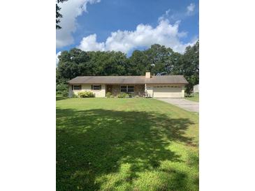 Ranch style home with mature landscaping and a spacious yard at 2705 Ranch Rd, Dover, FL 33527