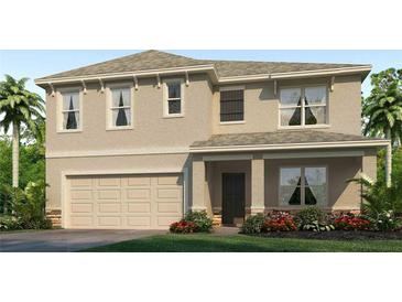 Two-story home with neutral siding, large garage, and landscaping at 3092 Living Coral St, Wimauma, FL 33598