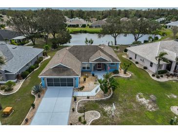 Charming single-story home with a two-car garage, lush landscaping, and a canal view at 2203 W Del Webb Blvd, Sun City Center, FL 33573