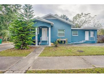 Quaint blue house with a well-maintained lawn and walkway at 2908 W Spruce St, Tampa, FL 33607