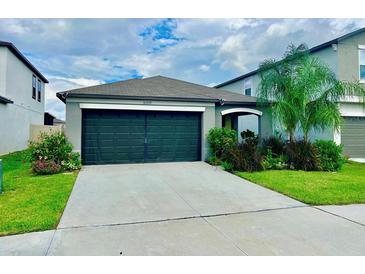 One-story home with two-car garage and landscaping at 31559 Barrel Wave Way, Wesley Chapel, FL 33545