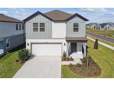 Charming two-story home features a two-car garage and well-manicured lawn at 6240 Golden Beach Dr, Apollo Beach, FL 33572