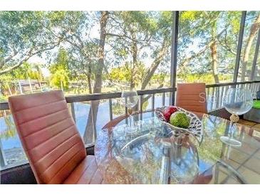 Bright dining area with water views and screened balcony at 9205 Tudor Dr # C209, Tampa, FL 33615
