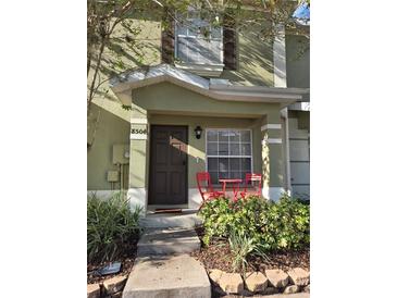 Inviting front entrance with red chairs at 8504 Brushleaf Way, Tampa, FL 33647