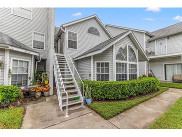 Exterior view of the condo building with a staircase and landscaping at 12267 Armenia Gables Cir # 12267, Tampa, FL 33612
