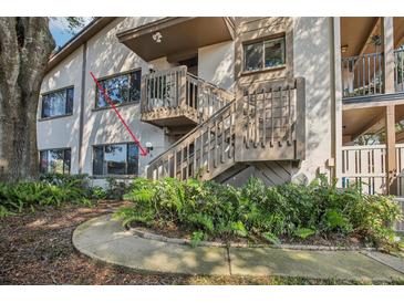 Exterior view of condo building with stairs and landscaping at 13012 Wedgewood Way # A, Hudson, FL 34667