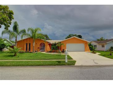 Charming single-story home with a two-car garage at 7906 Willow Brook Ct, Hudson, FL 34667