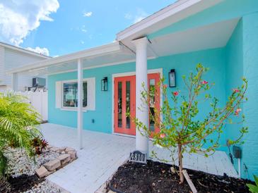 Charming beach cottage with coral exterior and double doors at 4810 Chancellor Ne St, St Petersburg, FL 33703