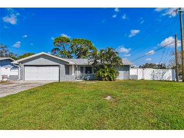 Ranch style home with a spacious lawn and two-car garage at 11303 86Th Ave, Seminole, FL 33772