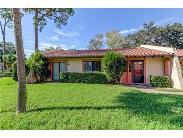 Single-story home with a red door and well-maintained lawn at 9537 86Th Ave # 9537, Seminole, FL 33777