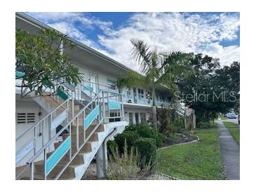 Two story building with teal accents and stairs at 5945 21St N St # 14, St Petersburg, FL 33714