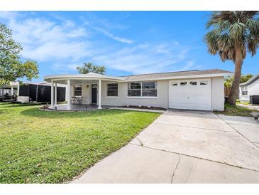 Newly renovated home with a covered porch and circular driveway at 3510 Allandale Dr, Holiday, FL 34691
