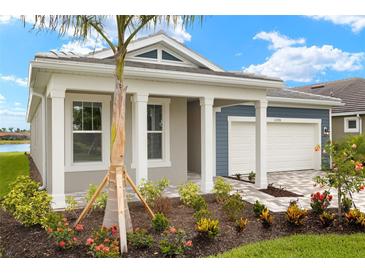 Charming single-story home featuring a two-car garage and beautifully landscaped front yard at 11720 Renaissance Blvd, Venice, FL 34293