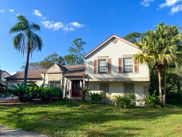 Two-story house with palm trees, a well-maintained lawn, and mature landscaping at 3712 Murray Dale Dr, Valrico, FL 33596