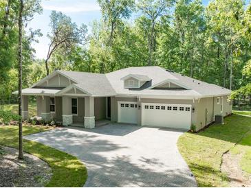 Beautiful single-story home with a three-car garage and charming curb appeal at 22426 Golden Retriever Ln, Brooksville, FL 34601