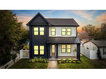 Modern two-story home with black and white siding, contrasting trim, and well-manicured front lawn at 476 43Rd N Ave, St Petersburg, FL 33703
