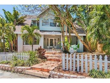 Charming two-story home features a welcoming front entrance and lush tropical landscaping at 532 Beach Ne Dr, St Petersburg, FL 33701
