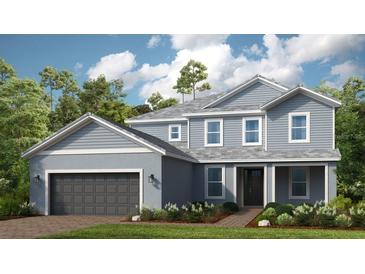 Two-story house with gray siding, dark gray garage door, and landscaping at 11178 Manor House Ln, Odessa, FL 33556