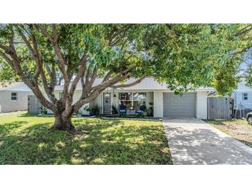 Charming single story home with a tree-filled front yard at 5410 Palm Drive, New Port Richey, FL 34652