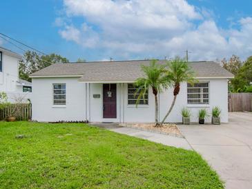 Charming one-story home with a purple door at 4406 W Wallcraft Ave, Tampa, FL 33611