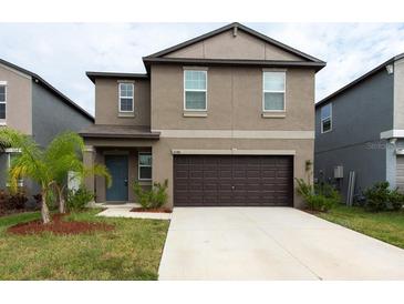 Two-story house with a two-car garage and landscaping at 10348 Blue Plume Ct, Riverview, FL 33578