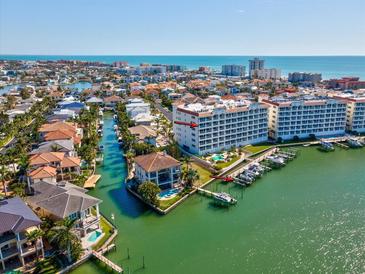 Beautiful aerial view of waterfront community with private boat slips and ocean views in the background at 17745 Gulf Blvd # 604, Redington Shores, FL 33708