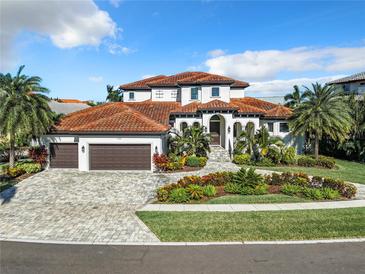 Luxury home with tile roof, three car garage, and landscaped yard at 949 Symphony Isles Blvd, Apollo Beach, FL 33572