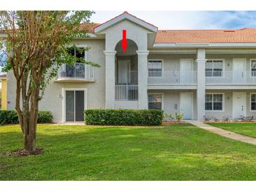 Condo building exterior with landscaping and walkway at 6801 Dali Ave # G205, Land O Lakes, FL 34637