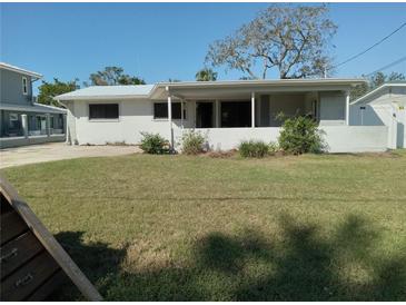 Single story home with covered patio and well-maintained lawn at 4310 Huntington Ne St, St Petersburg, FL 33703