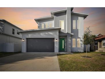 Modern two-story house with green door and gray exterior at 3119 W Cypress St, Tampa, FL 33607