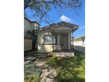 Cozy bungalow with front porch and small yard at 411 S Orleans Ave, Tampa, FL 33606
