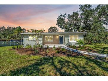 Newly renovated home with a modern facade and landscaped front yard at 12020 82Nd E St, Parrish, FL 34219