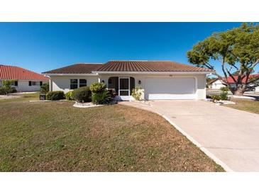 Charming single-story home featuring a tile roof, attached garage, and well-manicured front yard at 701 Westmont Way, Sun City Center, FL 33573