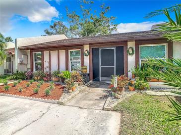 Inviting home exterior featuring a landscaped front yard and charming entryway at 8403 Wakulla Dr, Temple Terrace, FL 33637