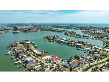 Stunning aerial view of waterfront homes with boat docks nestled in a tranquil community near the ocean at 7886 9Th S Ave, St Petersburg, FL 33707