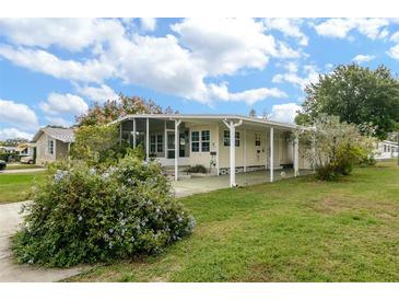Ranch style home with covered carport and landscaped yard at 176 Philadelphia Lot 5 Blvd, Palm Harbor, FL 34684