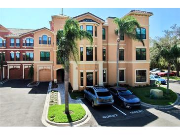 Luxury condo building with palm trees and ample parking at 2717 Via Cipriani # 622B, Clearwater, FL 33764