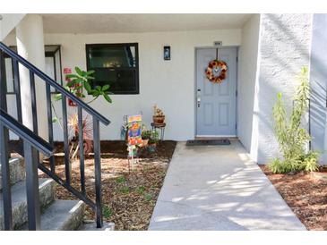 Inviting condo exterior with landscaping and walkway at 1901 Oyster Catcher Ln # 814, Clearwater, FL 33762
