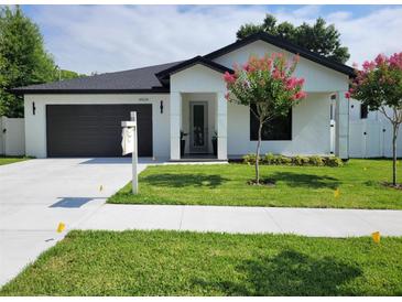 Modern single story home with attached garage and landscaping at 4504 N Eddy Dr, Tampa, FL 33603