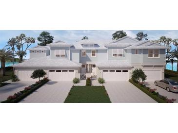 Modern light blue three-unit building with attached garages and landscaping at 31879 Anchor Point Dr, Wesley Chapel, FL 33545