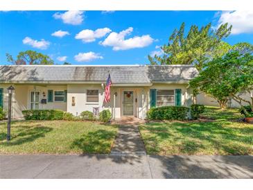 Quaint one-story home with a manicured lawn at 1454 Normandy Park Dr # 1, Clearwater, FL 33756