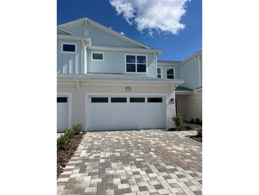 Charming two-story home with brick paver driveway and attached two car garage at 31901 Anchor Point Dr, Wesley Chapel, FL 33545