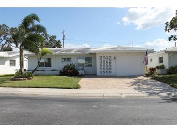 Ranch style home with a landscaped yard and attached garage at 4460 95Th N Ave # 1, Pinellas Park, FL 33782